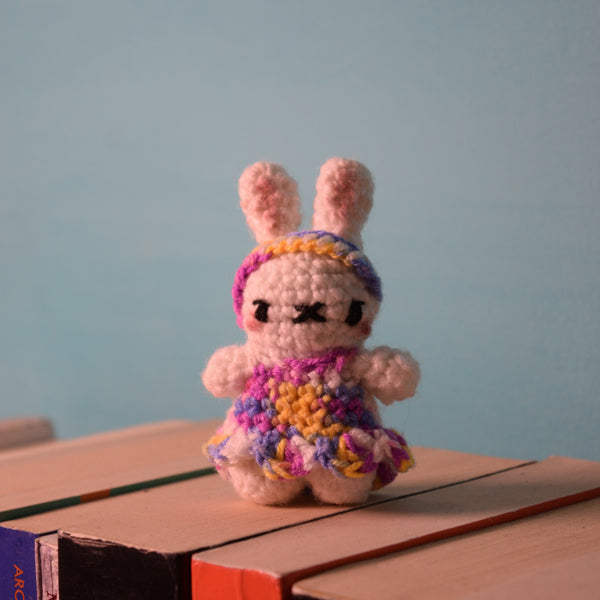 Handmade crochet rabbit in a dappled rainbow sweater