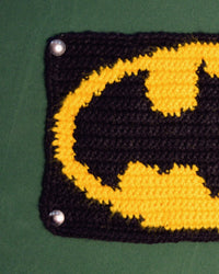 Close view of a handmade crochet wall panel showing the stitch detail