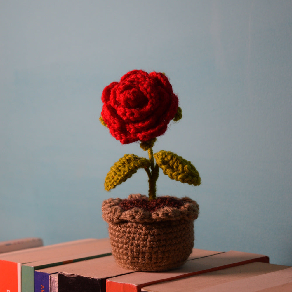Handmade crochet red rose in a textured brown pot