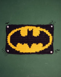 Handmade crochet wall panel in black and gold, an example of custom design work