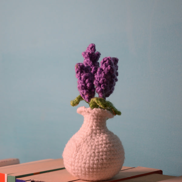 Handmade crochet lavender hyacinth blooms in a delicate white vase